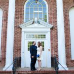a wide angle shot of WM and Kim in front of a courthouse. There are tall columns and arched windows. We are standing in front of the doors staring at each other. It was over 90 degrees at 8:30am.