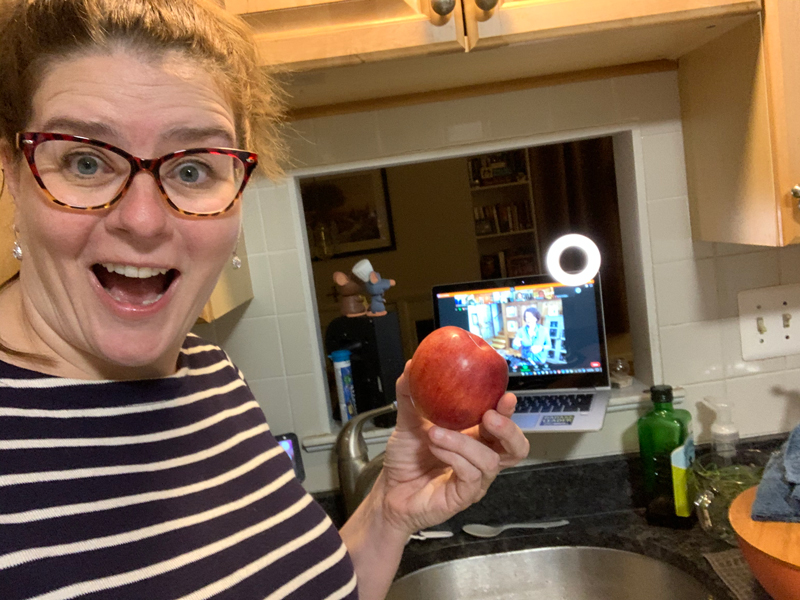 kim holding an apple and looking silly