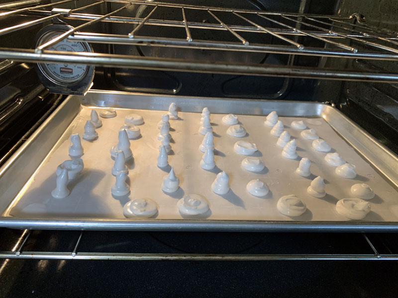 meringue mushroom caps and stems in the oven