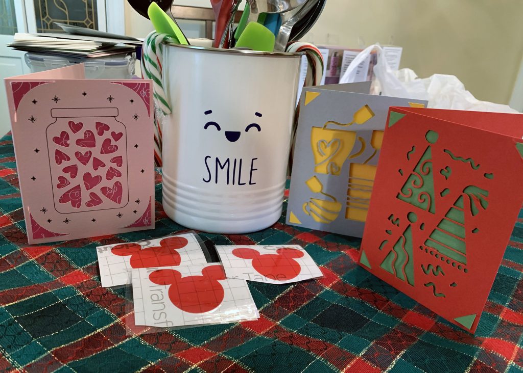 photo of 3 greeting cards, 3 mickey stickers, and a utensil crock with a weird smile on it