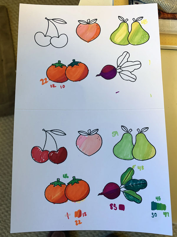 a sheet of partially colored vegetables