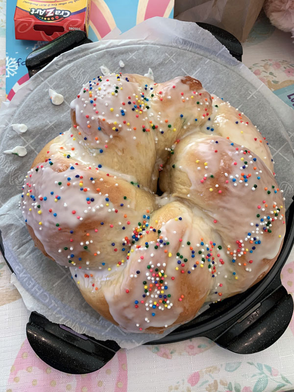 a round loaf of sweet bread, frosted with sprinkles