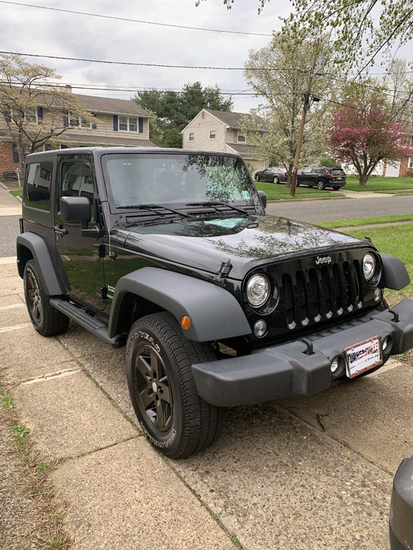 a very shiny and new black Jeep Wrangler