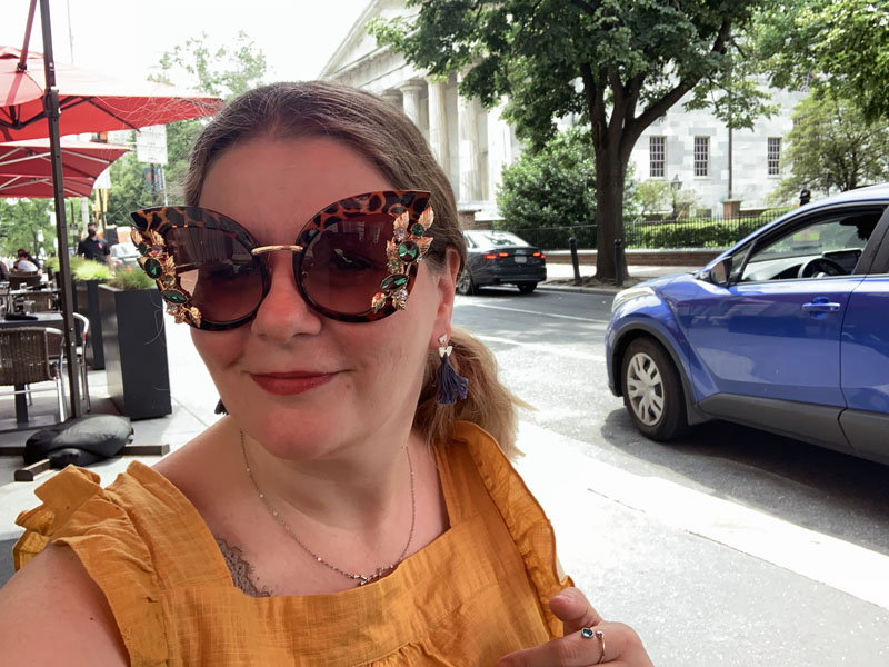 Me, in a yellow sun dress and absolutely WILD sunglasses with leopard print and gems on it. I did not photoshop this picture other than adjusting the light, and it's making me a little uncomfortable that I didn't.