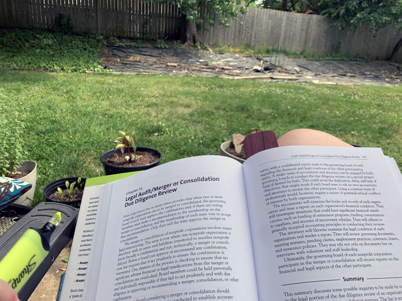 A gripping photo of an Association Law book open to the chapter about Due Diligence Review of a Merger or Consolidation. And my crummy lawn.