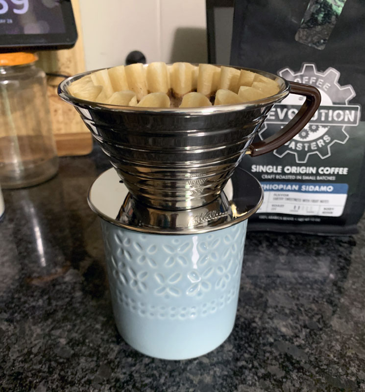 a pour-over contraption on top of a coffee cup