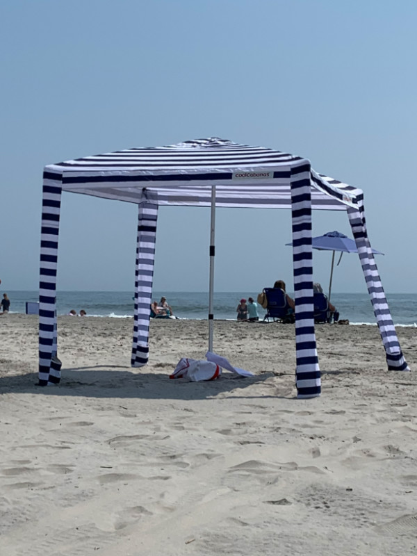 a weird umbrella/cabana structure on the beach.