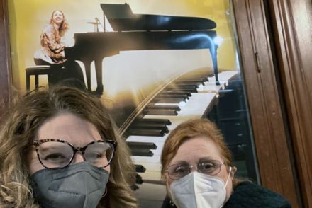 kim and her mom in front of a poster for the musical