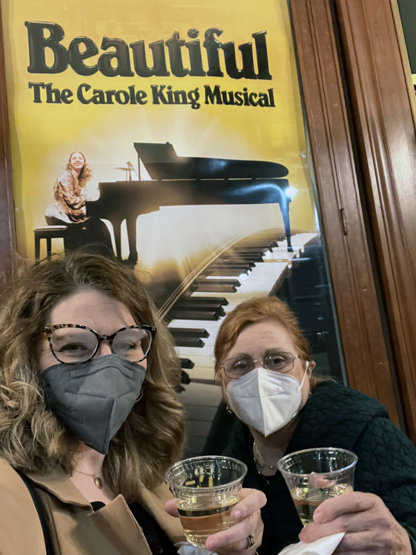kim and her mom in front of a poster for the musical
