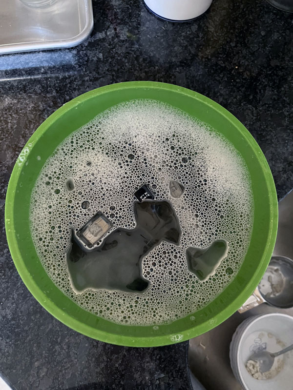 keycaps soaking in a bowl of water and dawn