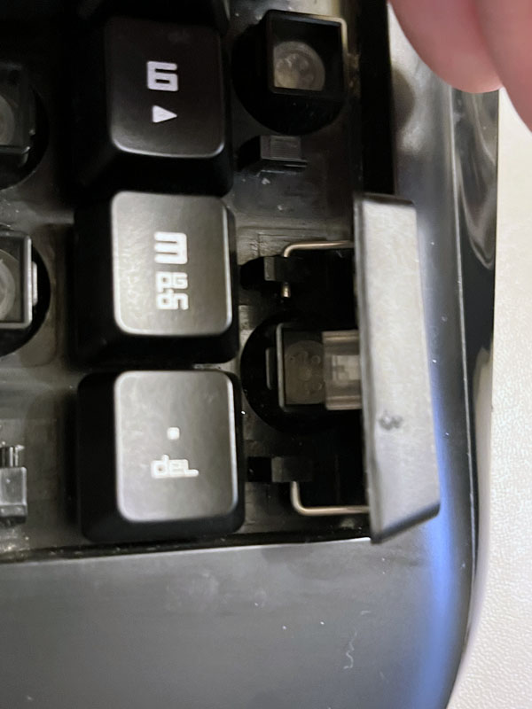 closeup of a keycap with a metal bar beneath it