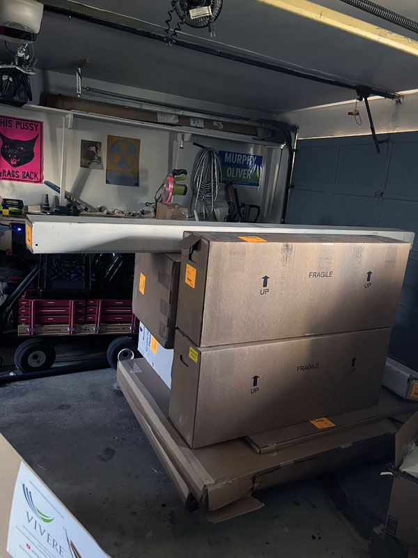 giant boxes on a pallet. not pictured: Kim's simmering doubt that this will fit in the proper room and her sinking feeling that her craft room will be completely overtaken.