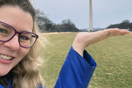 Kim, cheesily pretending to hold the Washington Monument in her hand.