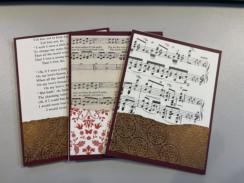 three valentine cards: each one has a front made of torn pages from old books, and leftover cardstock