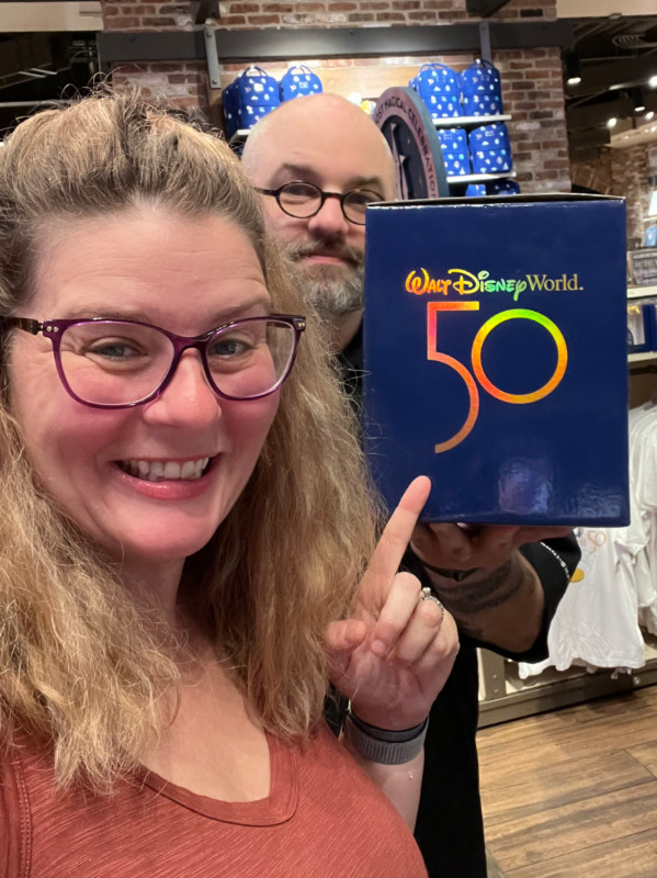 kim cheesily pointing at a Walt Disney World 50th anniversary product