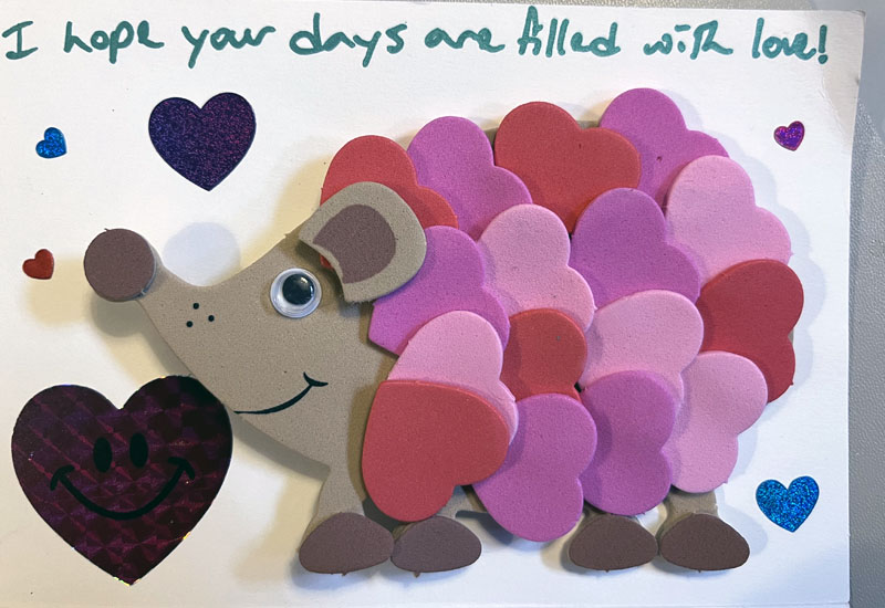 a hedgehog made of small foam hearts and a googly eye
