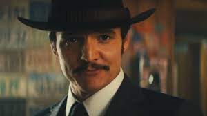 Pedro Pascal as Agent Whisky. He is wearing a suit and a cowboy hat.