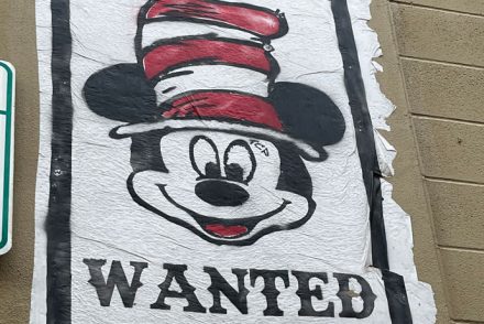 street art in Austin TX - Mickey Mouse with a Seuss hat and "WANTED" underneath