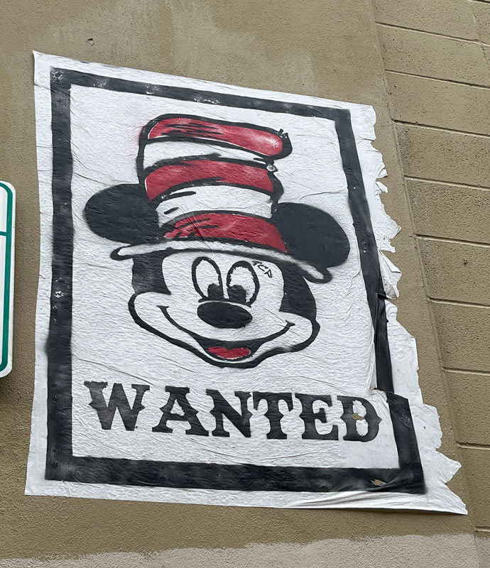 street art in Austin TX - Mickey Mouse with a Seuss hat and "WANTED" underneath
