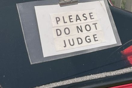 a sign on a car at the Mayfair car show that reads Please do not Judge