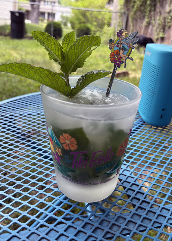 a mojito in a Tinker bell themed tiki glass.