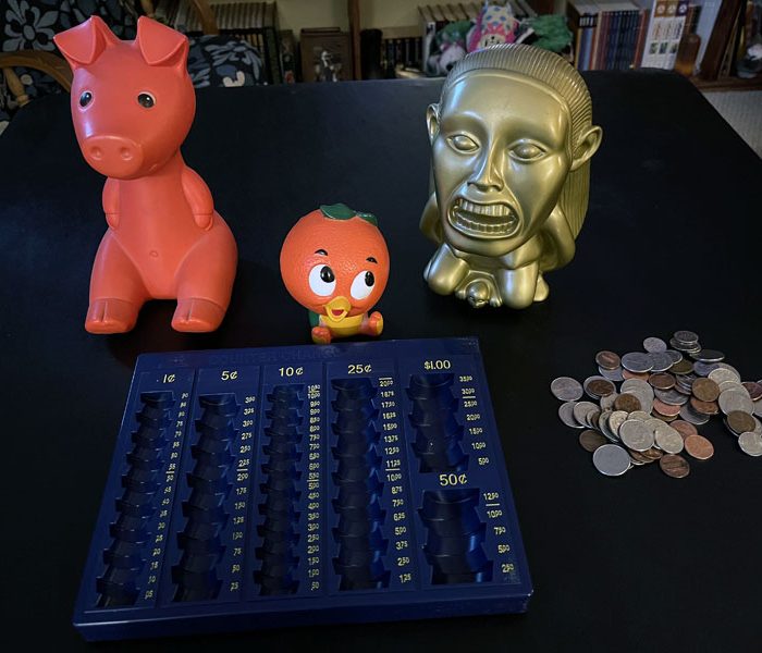 three plastic banks and a coin counting tray