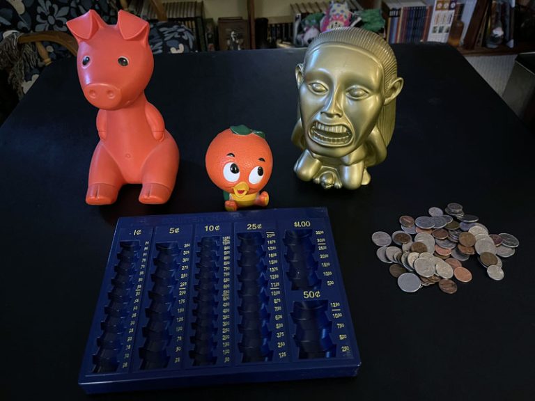 three plastic banks and a coin counting tray