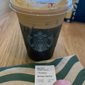 Starbucks birthday order: a pumpkin cream cold brew and a birthday cake cake pop. The label has my name on it.