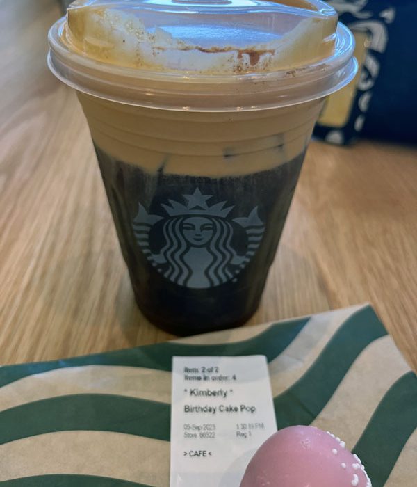 Starbucks birthday order: a pumpkin cream cold brew and a birthday cake cake pop. The label has my name on it.