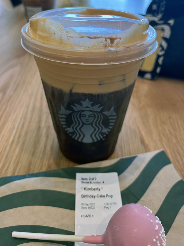 Starbucks birthday order: a pumpkin cream cold brew and a birthday cake cake pop. The label has my name on it.