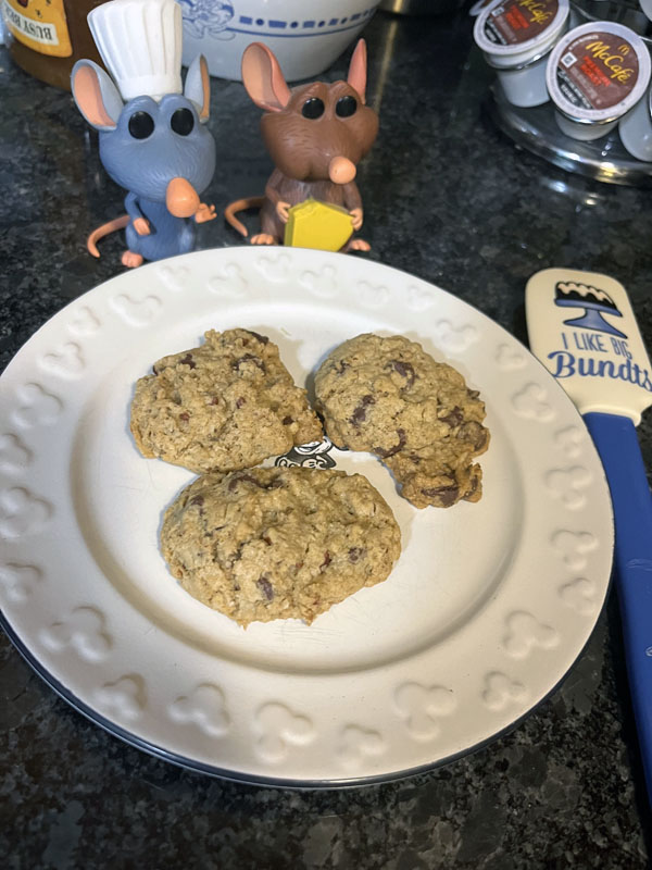 a plate of cowboy cookies with my Remy and Emile figurines looking on approvingly