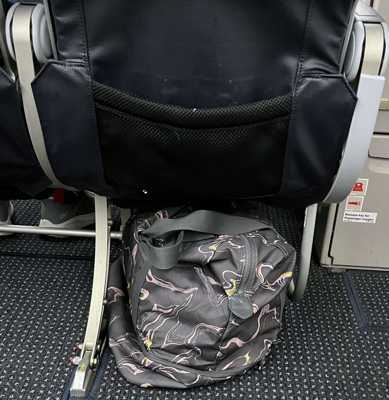my kipling weekender shoved under the airplane seat in front of me.