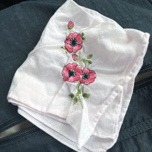 an old handkerchief with pink embroidered flowers