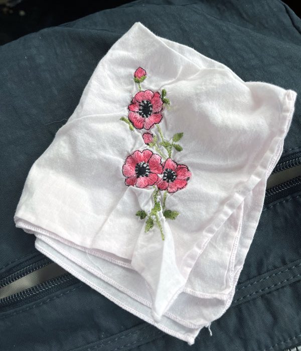 an old handkerchief with pink embroidered flowers