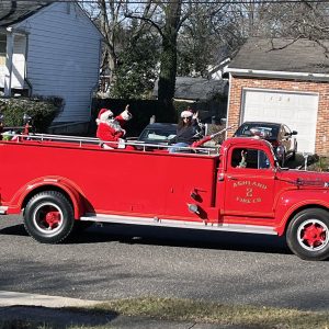 Santa on an old firetruck.