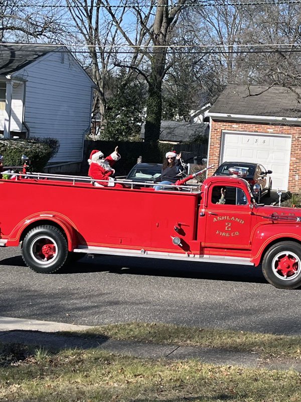 Santa on an old firetruck.