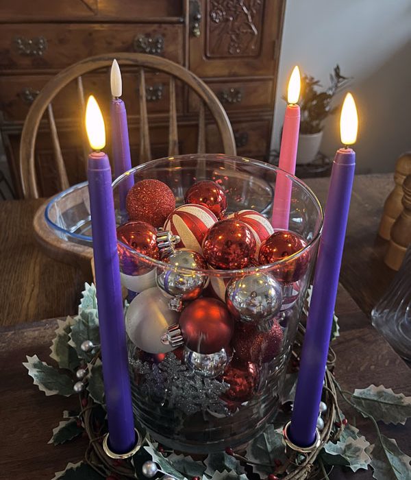 Kim's advent wreath with three candles lit: 2 purples and a pink.