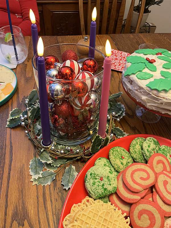 Kim's Advent Wreath with all four candles lit, surrounded by cookies and cake, because it's Christmas eve!