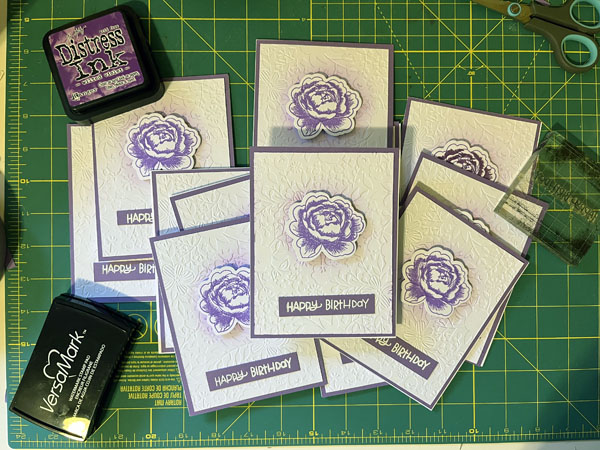 February cards, purple inked flowers on a white textured background and "happy birthday" on the front