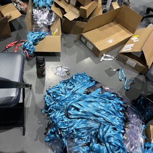 a gigantic pile of sea-blue lanyards with empty plastic badge holders clipped to them