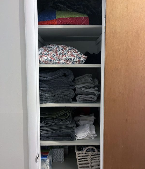 my linen closet, with blankets, sheets, and towels, all folded.