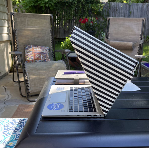 my laptop on the patio table with a laptop shade on it