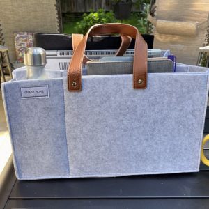 A gray, mostly-felt tote to carry work items around the house