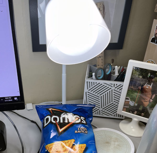 an ottlite, bag of doritos, and a mug warmer