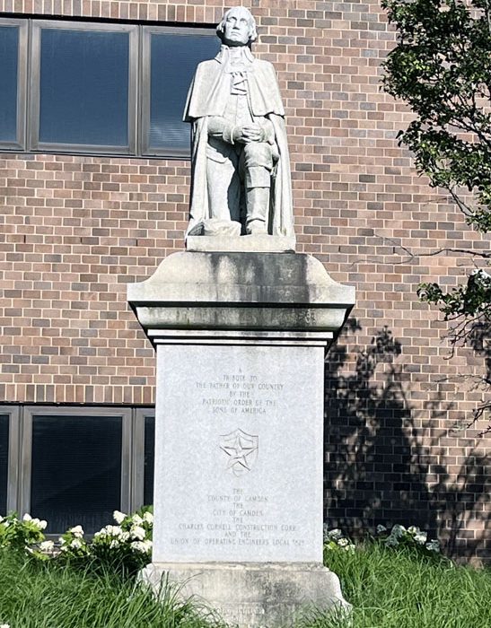 a statue of george washington in front of the camden county courthouse