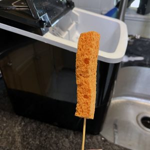 a strip of orange sponge on a skewer