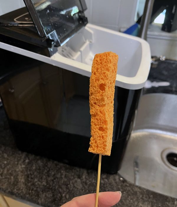 a strip of orange sponge on a skewer