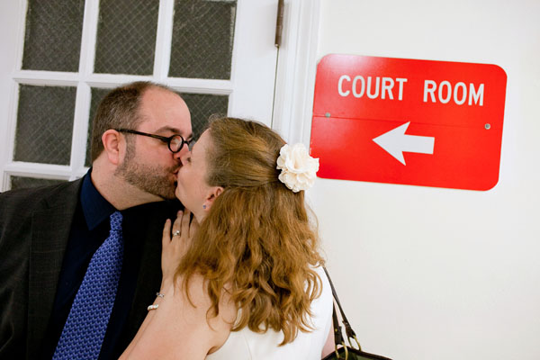 kim and wm smooching at the courthouse in 2012 in front of a sign that says court room