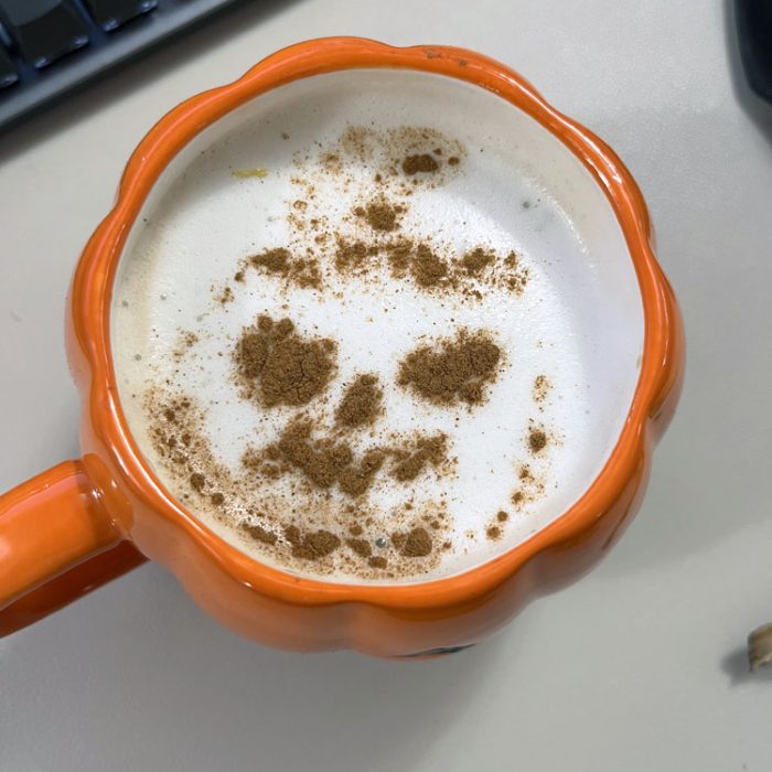 a very poorly done stencil of a jack o lantern on top of a coffee