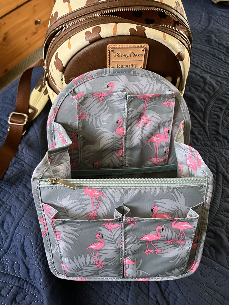 a flamingo print mini backpack insert in front of a Loungefly backpack